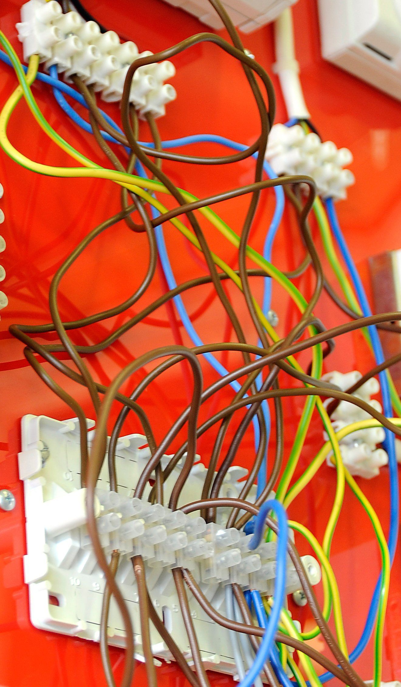 A bunch of wires are laying on a red surface