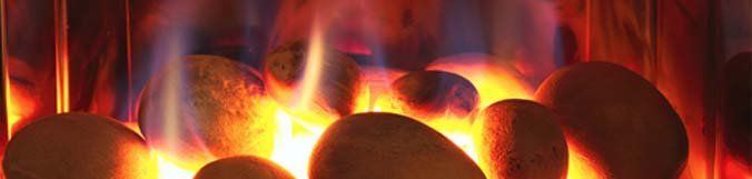 A close up of a fireplace with flames coming out of it.