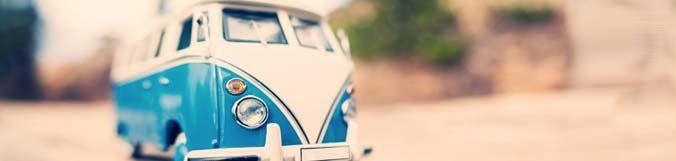 A blue and white toy van is sitting on the ground.