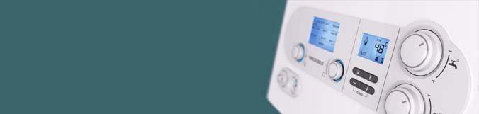 A close up of a white thermostat on a blue background.