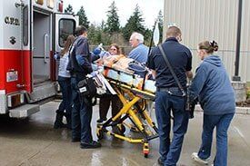 Patient on stretcher getting inside ambulance - Medical personnel in Upland, CA Patient on stretcher getting inside ambulance - Medical personnel in Upland, CA