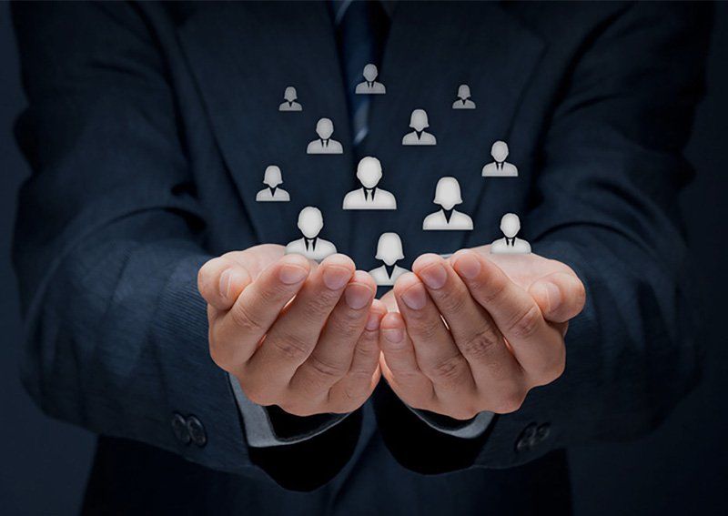 Hands holding icons of anonymous people
