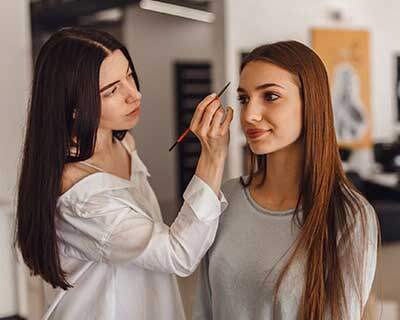 Cosmetology Career Institute — Woman Having Make Up From Make Up Artist in Washington, DC Cosmetology Career Institute — Woman Having Make Up From Make Up Artist in Washington, DC