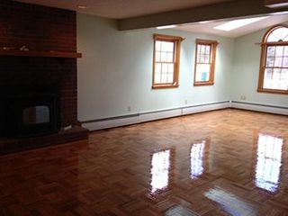 Empty Hardwood Floor Living Room with Fireplace - Portland, ME Empty Hardwood Floor Living Room with Fireplace - Portland, ME
