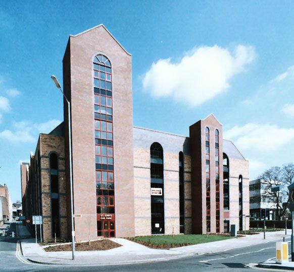 Large building fronted by two towers of varying height