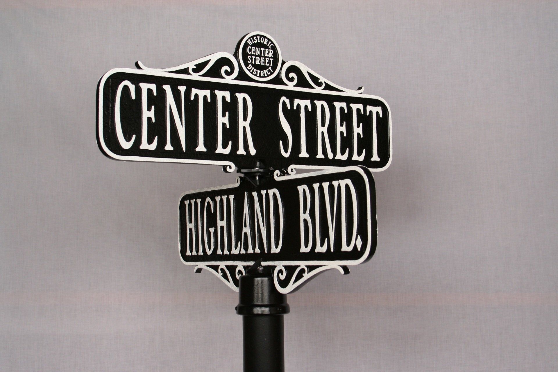 A street sign for center street and highland blvd.