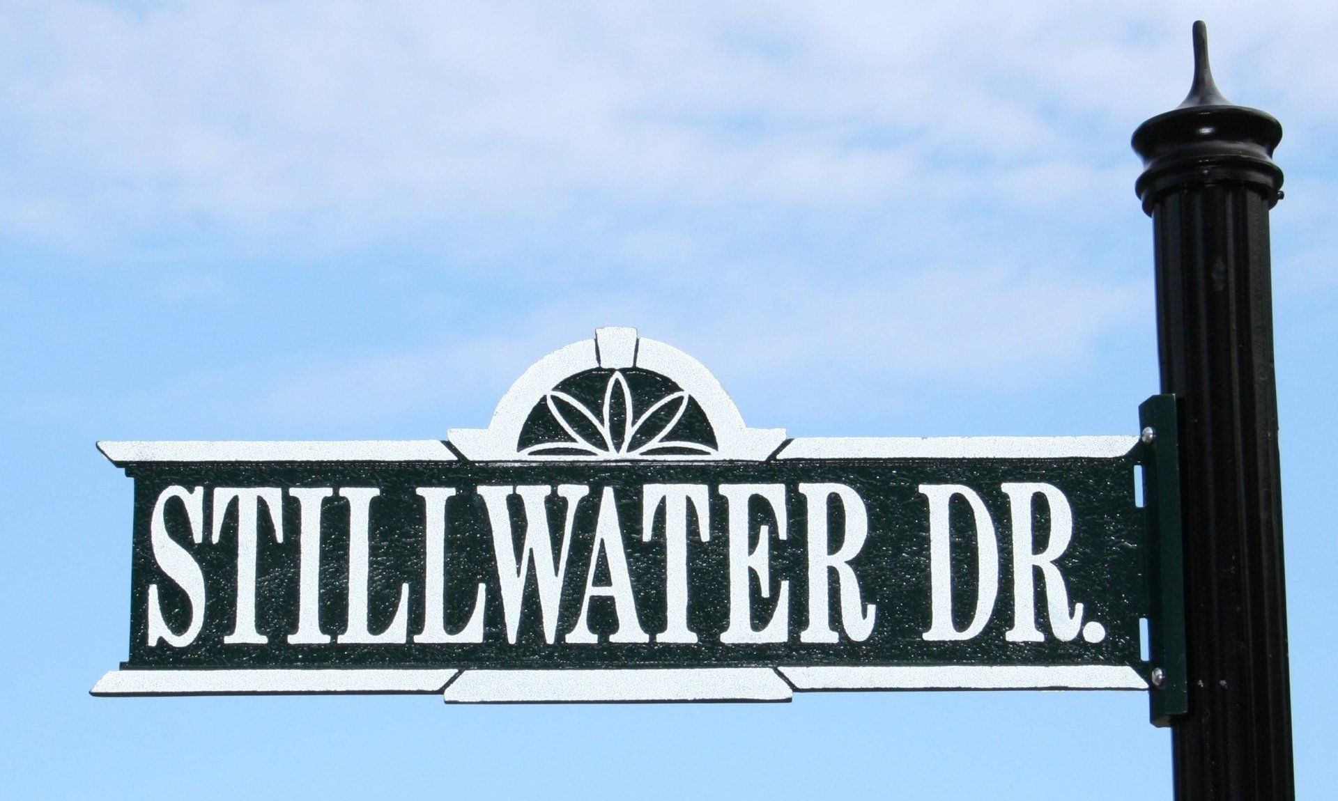A street sign that says stillwater dr. on it