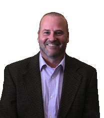 A man in a suit and a purple shirt is smiling