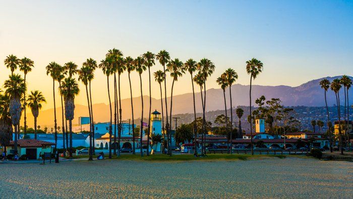 Santa Barbara sunset with palm trees and mountains in the background