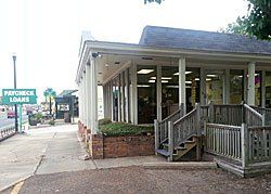 Payday loan business with porch, windows, sign, and sidewalk.