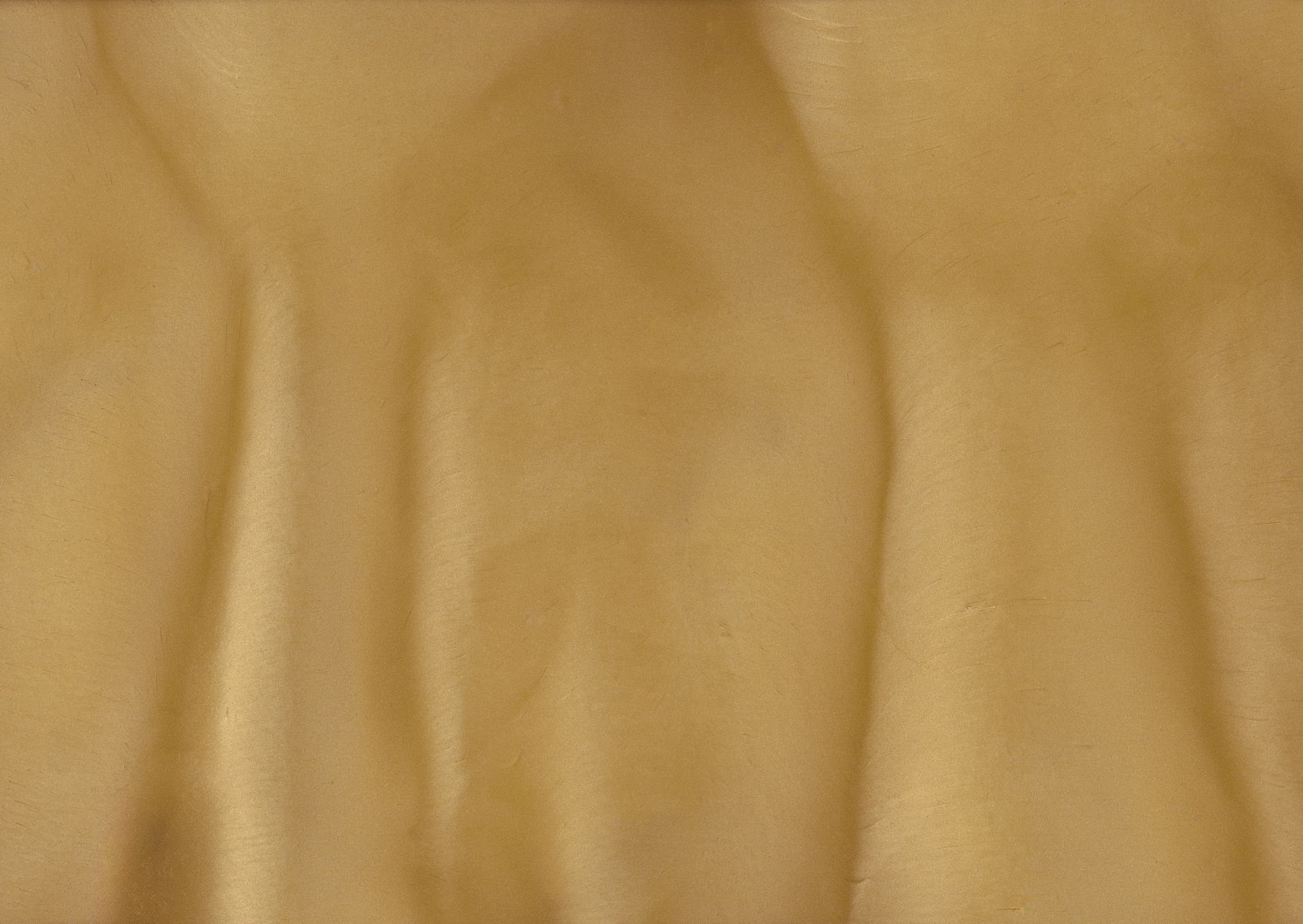 Yellow fabric with soft folds and shadows, possibly silk or a similar drape.