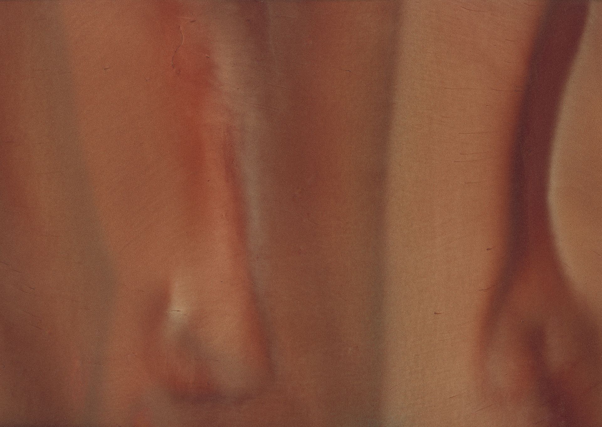 Close-up of pale skin with a reddish area, likely an arm or leg. The details are blurred.