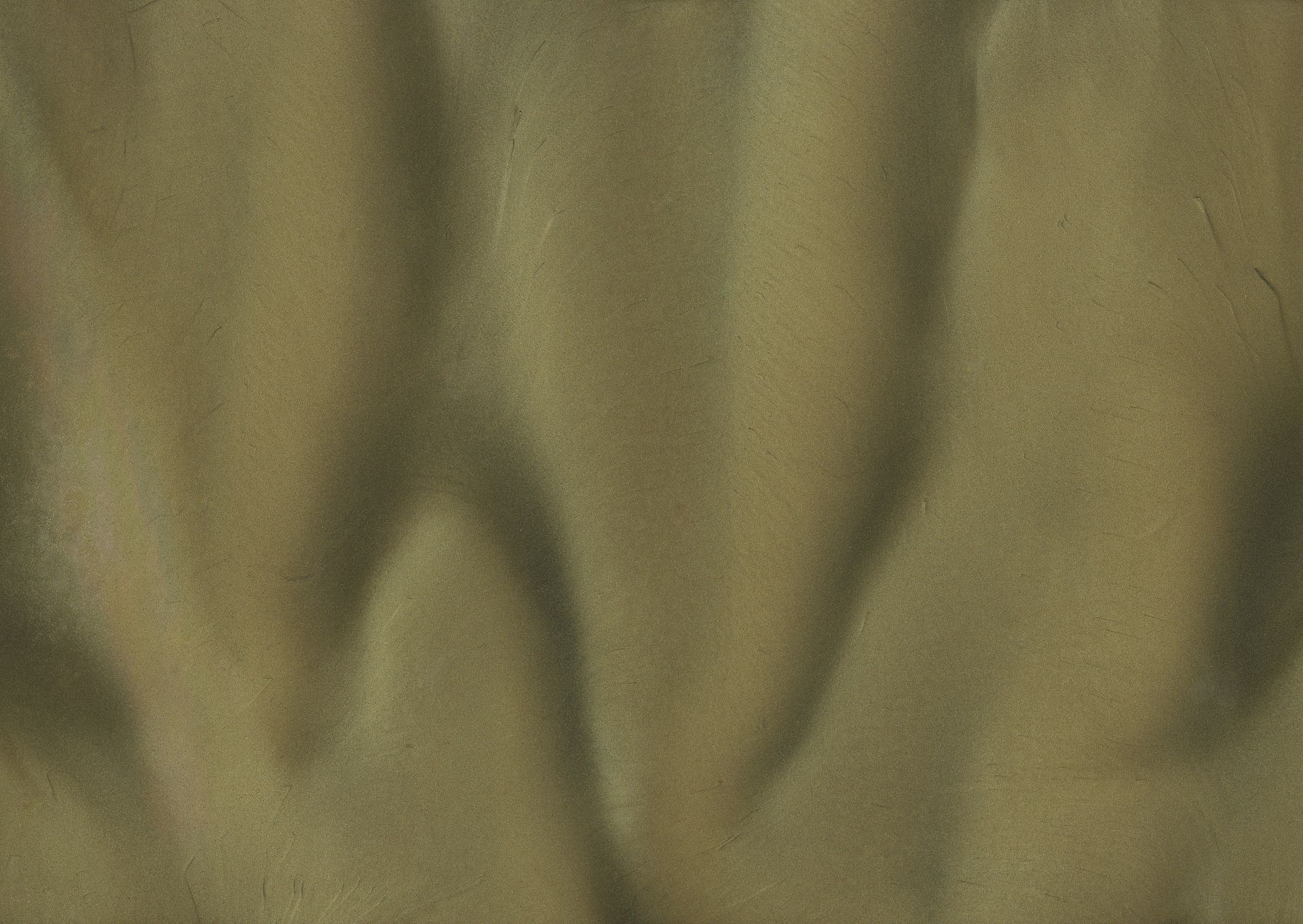 Green fabric with a rippled texture, creating shadows and highlights.