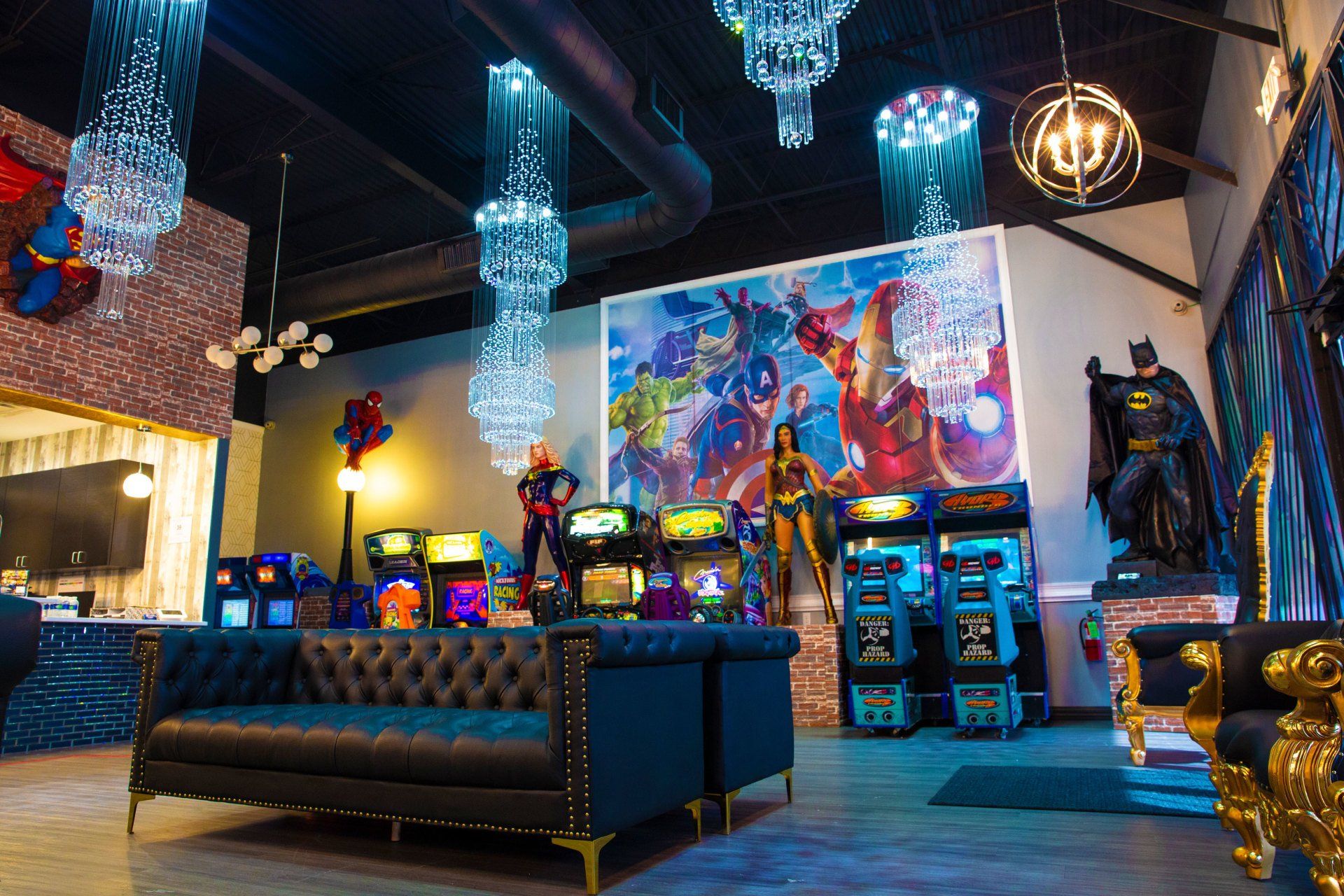Stylish arcade lounge with neon lights, gaming machines, a black sofa, and colorful wall art