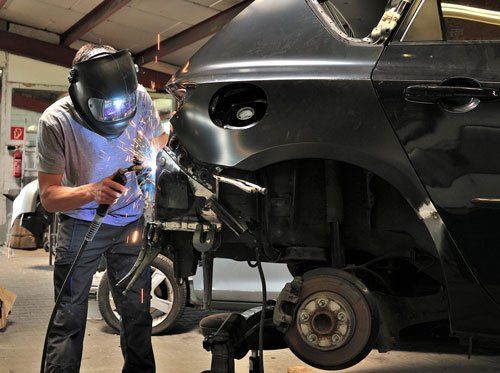 Worker welding car body