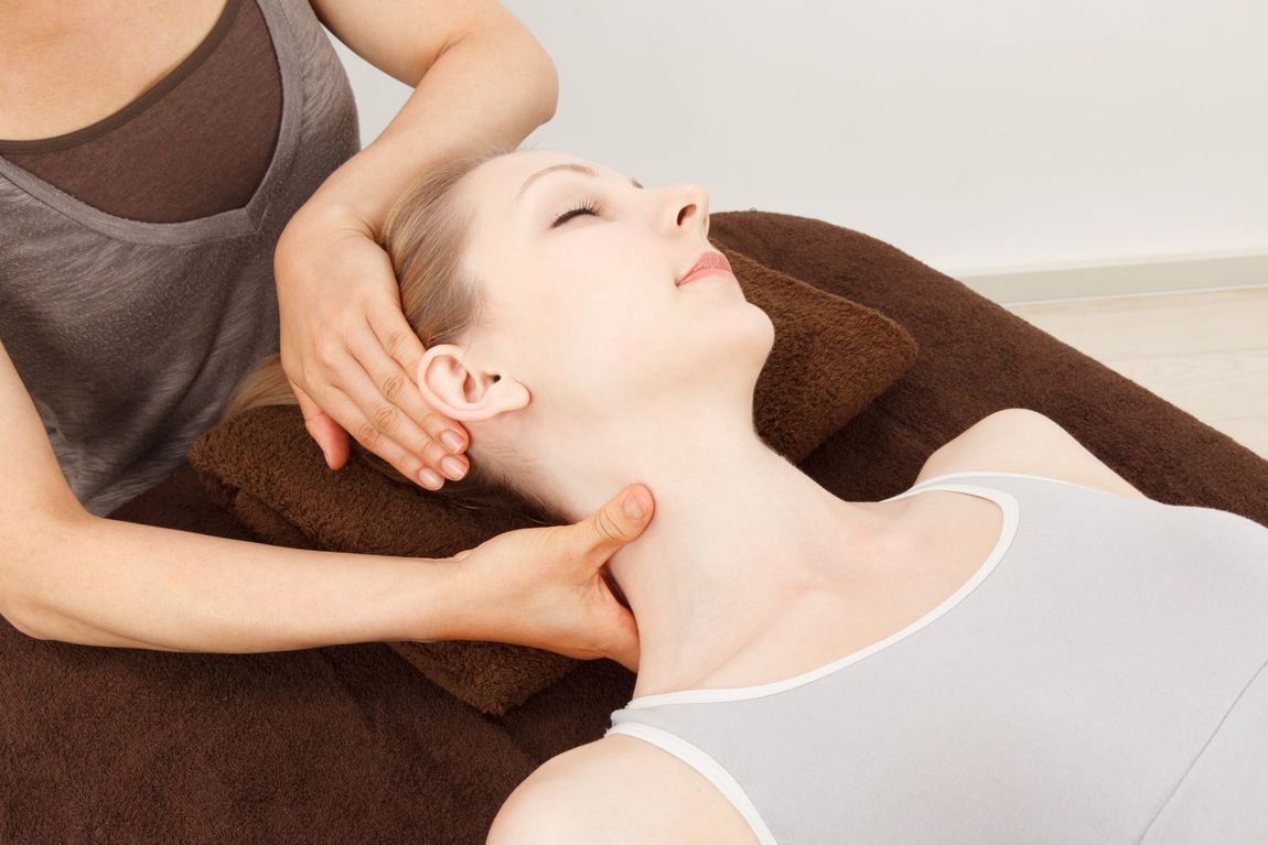 Woman receiving neck massage.
