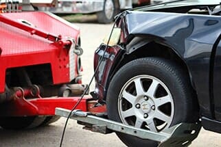 Long-distance Towing — Car Hitched To Tow Truck in Missoula, MT