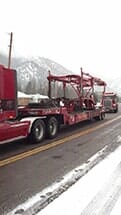 Idaho — Red Tow Truck Hauling Equipment in Missoula, MT
