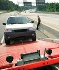SUV Being Loaded onto Tow Truck - Roadside Assistance in Erie, PA SUV Being Loaded onto Tow Truck - Roadside Assistance in Erie, PA