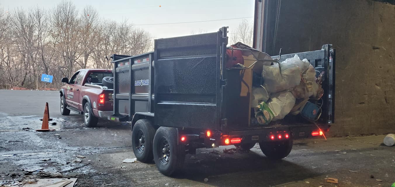 Black Dumpster Loaded with Junk — Minneapolis, MN — Eddie's Junk Removal