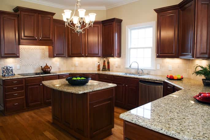 Gourmet kitchen with dark wood cabinets and granite countertops