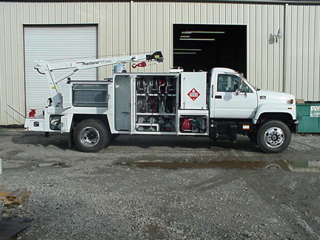 A white truck is parked in front of a building