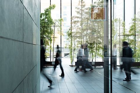 Business people walking through a lobby.