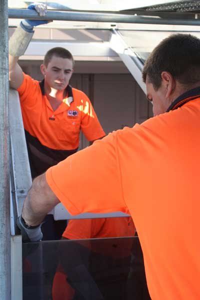 two workers installing glass