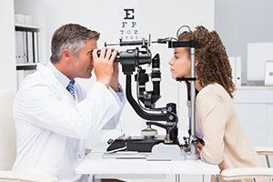 Eye Treatment — Woman doing Eye Test with Optometrist in Durango, CO Eye Treatment — Woman doing Eye Test with Optometrist in Durango, CO