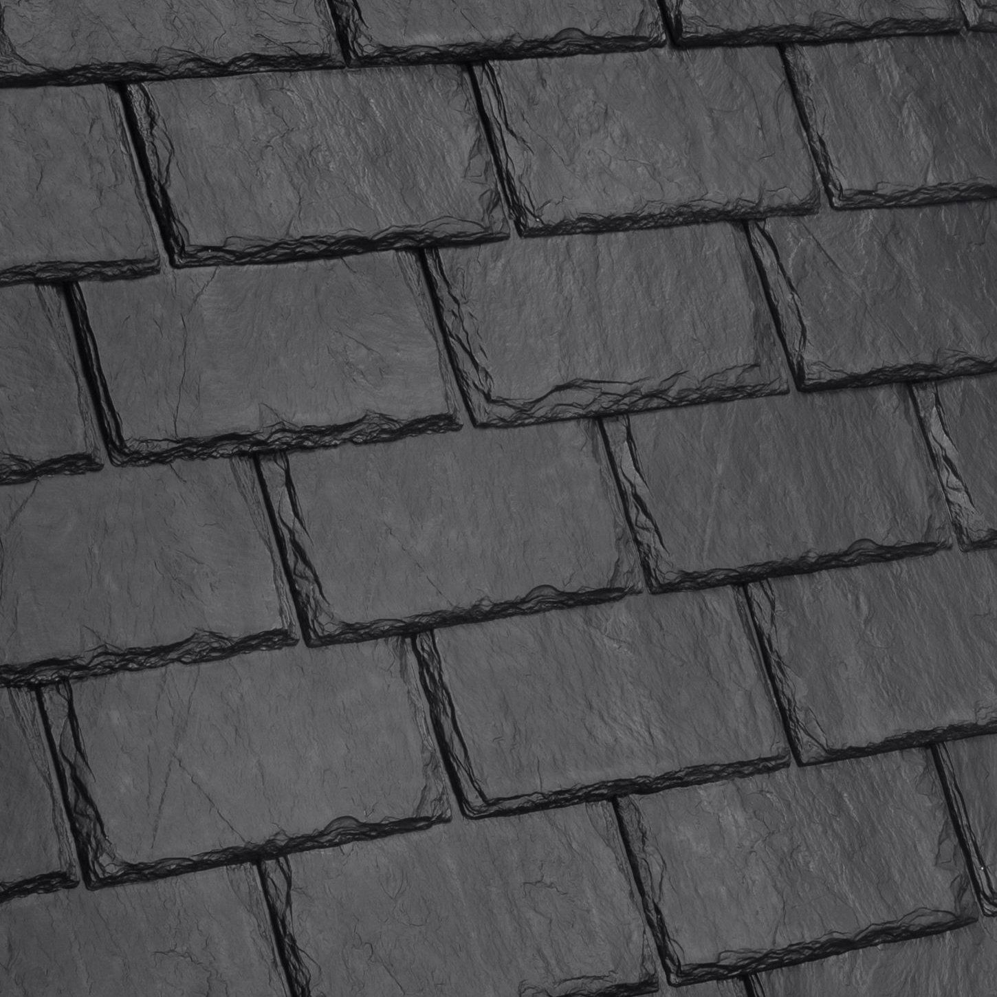 A close up of a black slate roof tile.
