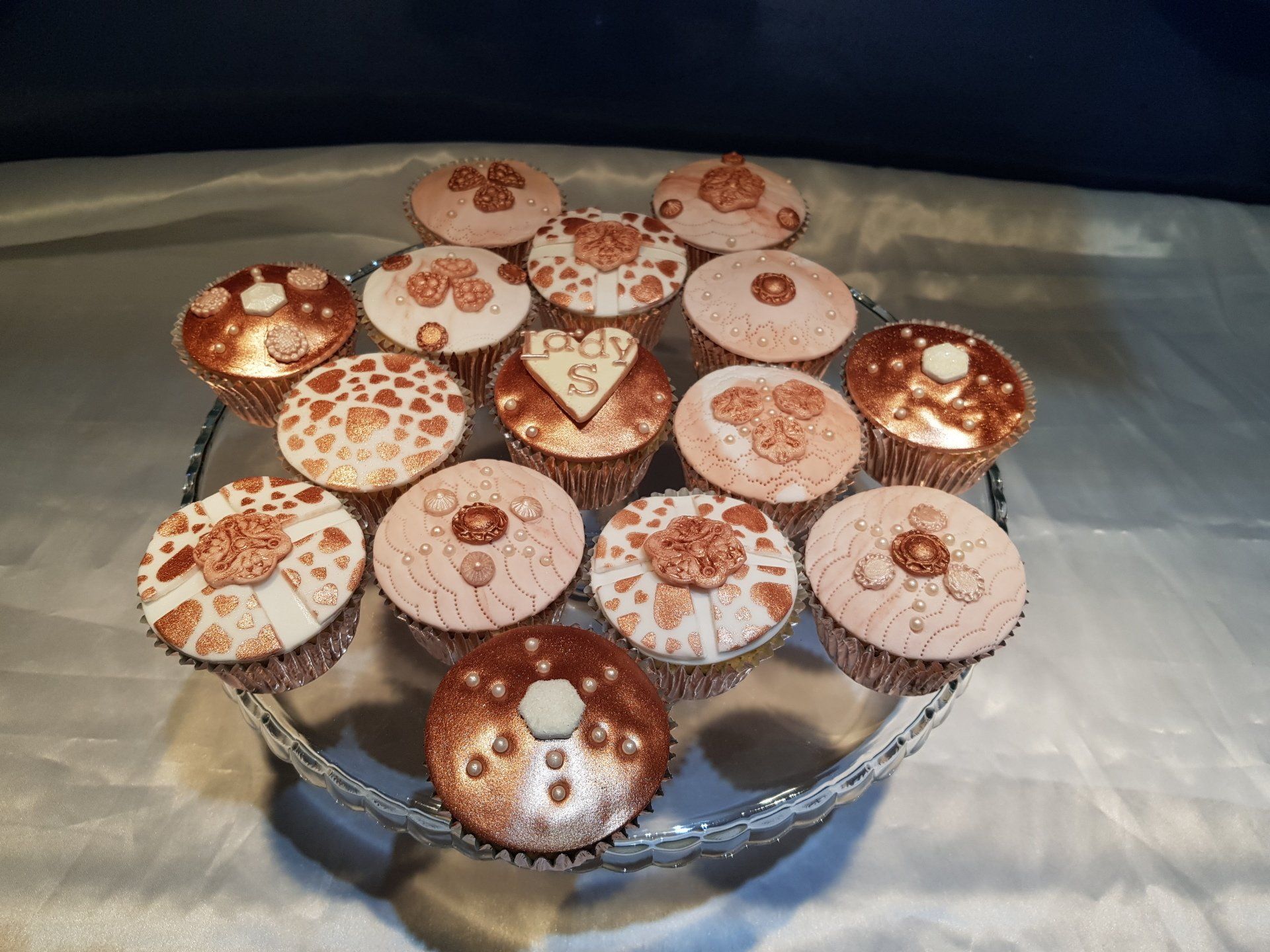 A bunch of cupcakes are sitting on a glass plate