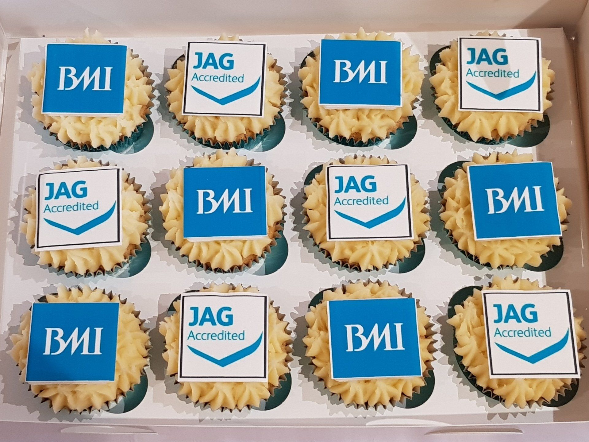 A box of jag bmi cupcakes with blue frosting
