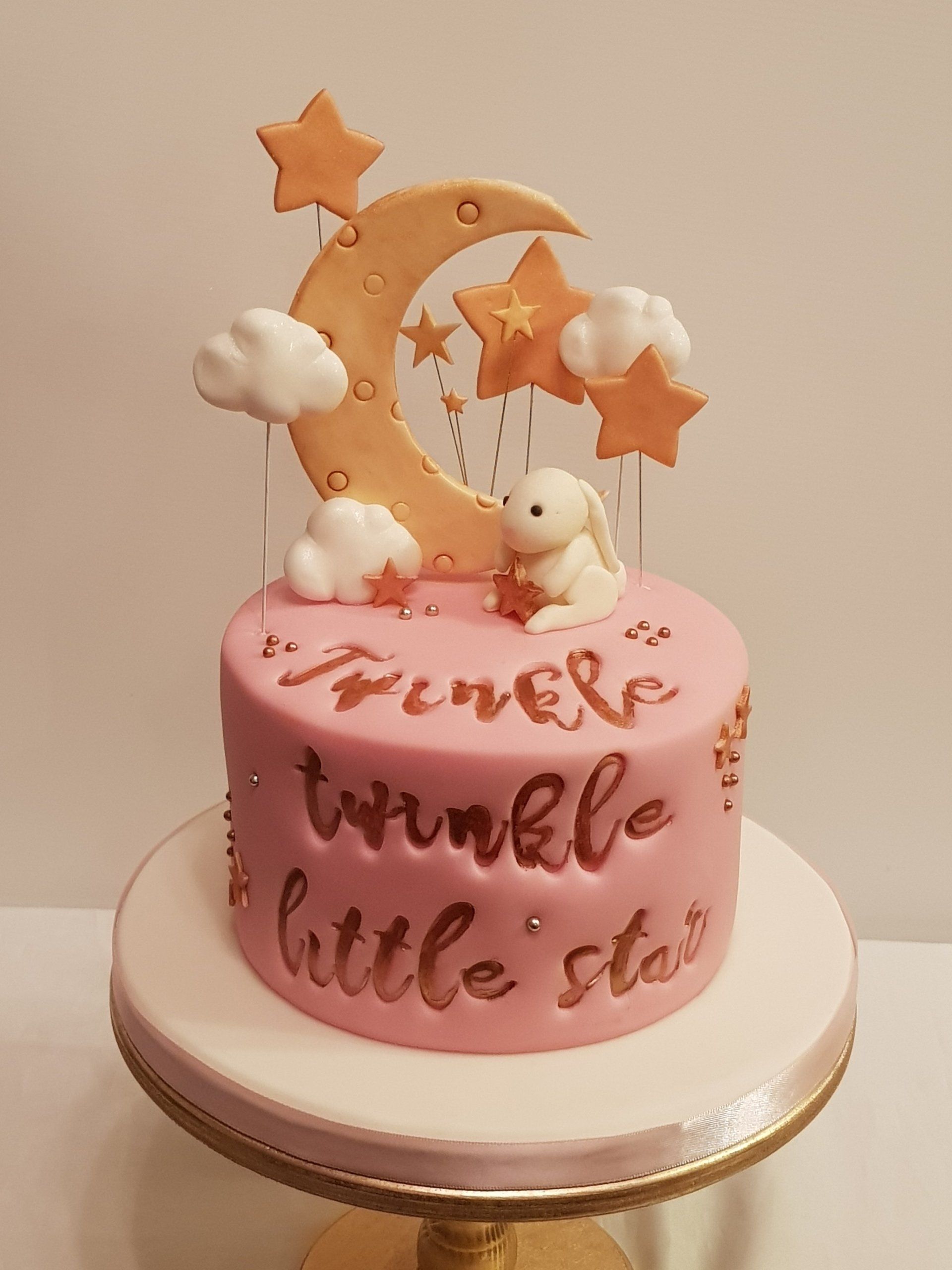 A pink cake with the words twinkle little stars on it