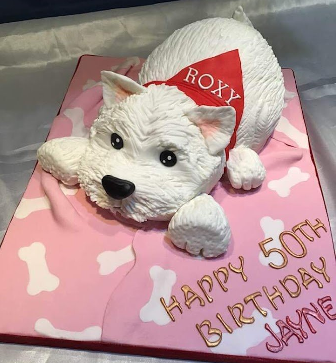 A 50th birthday cake with a white dog on it