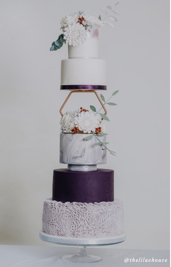 A wedding cake is stacked on top of each other on a cake stand.