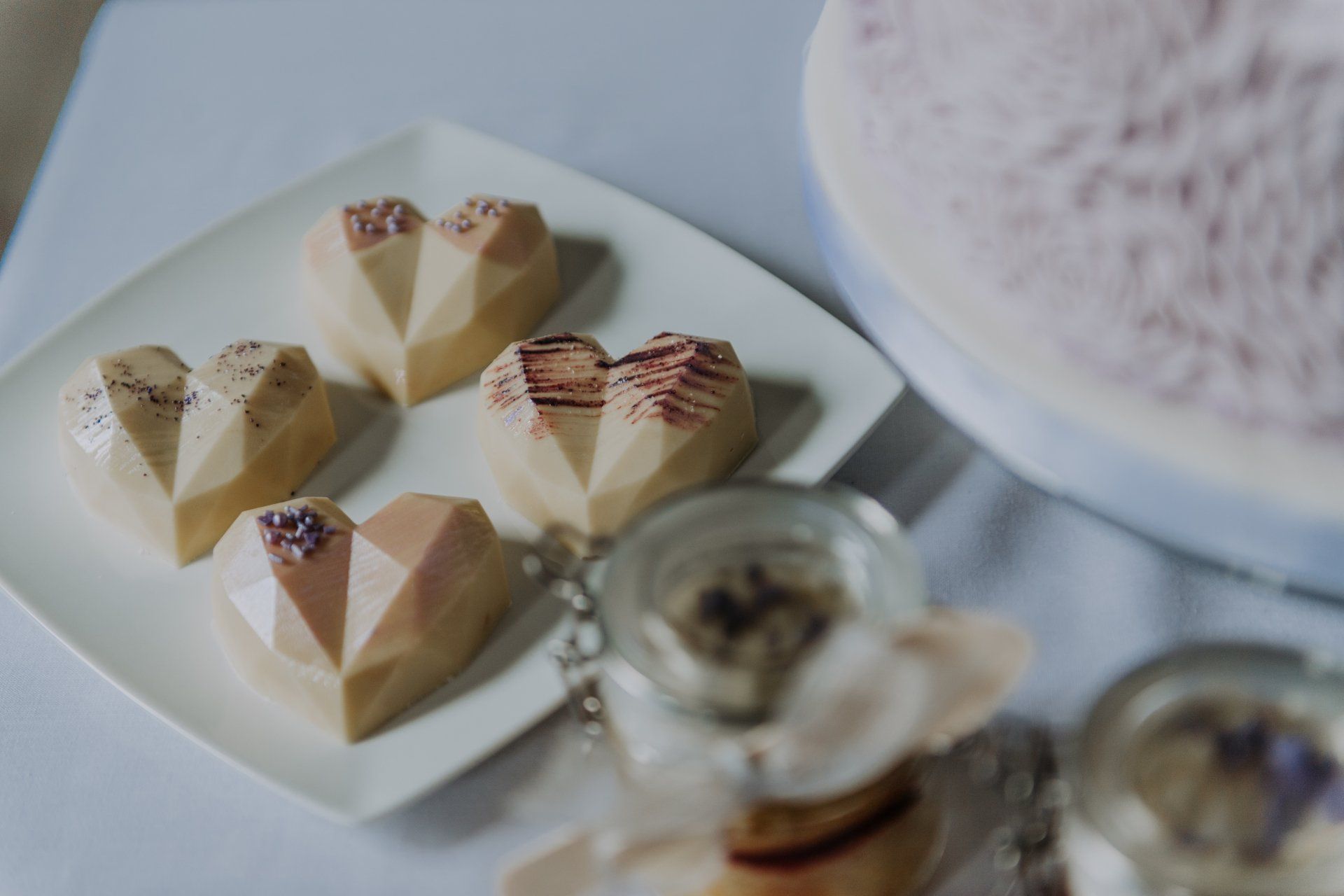 A white plate topped with heart shaped desserts on a table.