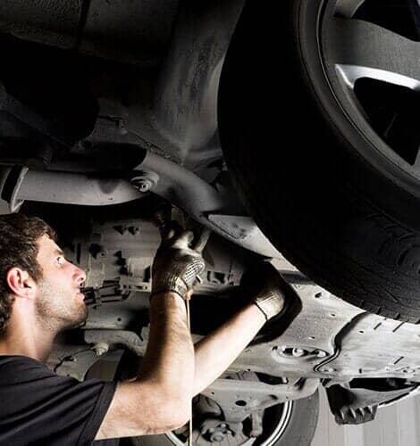 Auto Mechanic Working Under The Car — Auto Repair in Portland, OR Auto Mechanic Working Under The Car — Auto Repair in Portland, OR