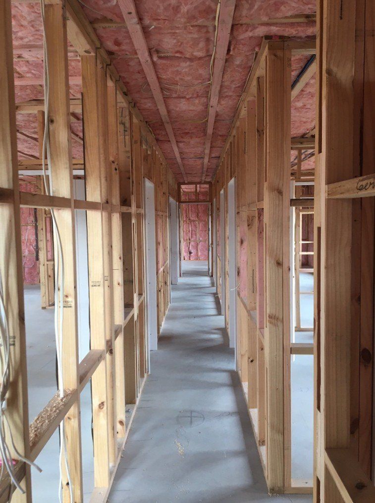 A long hallway in a building under construction.