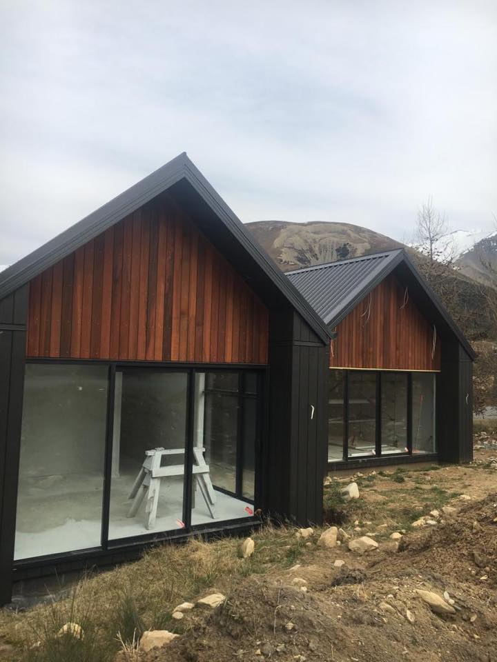 A couple of houses sitting next to each other on top of a hill.