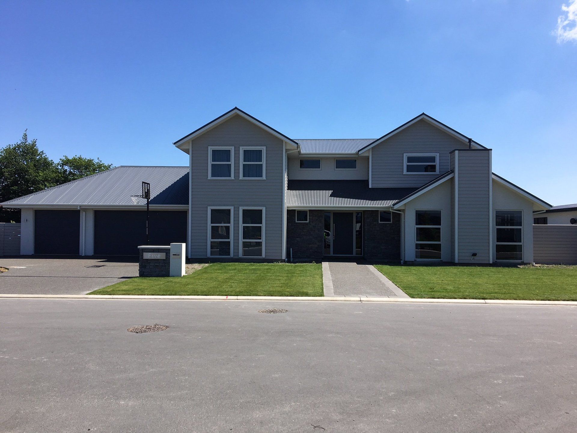 A large house with a blue sky in the background