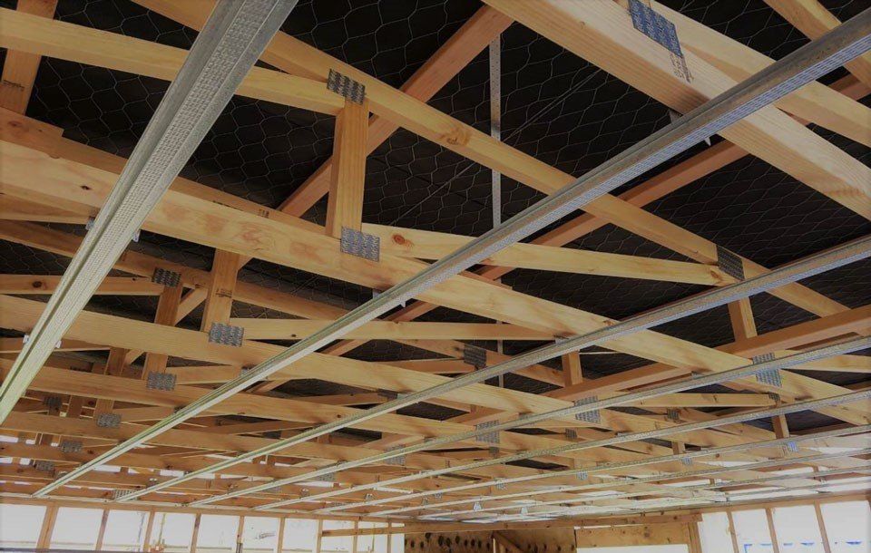 The ceiling of a building is made of wood and metal