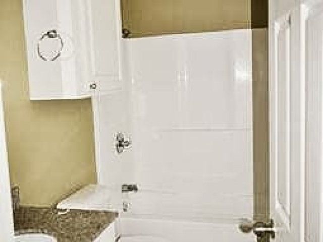 Bathroom with small vanity and cabinet over toilet