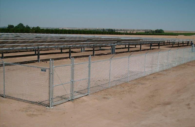 Chainlink fence in sand — Wood Fences in Bakersfield, CA