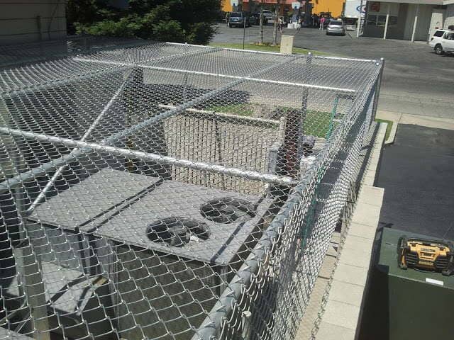 Machine covered with chainlink fence— Wood Fences in Bakersfield, CA