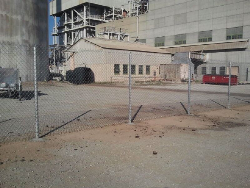 Factory with chainlink fence — Wood Fences in Bakersfield, CA