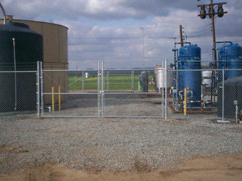 Chainlink fence gate in factory — Wood Fences in Bakersfield, CA