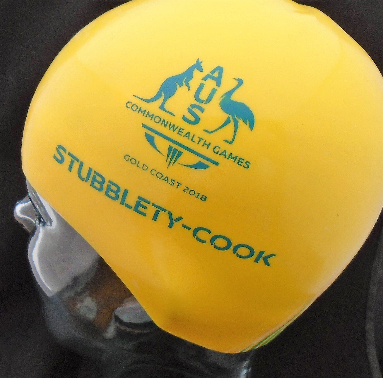 A yellow helmet that says stubblety-cook on it