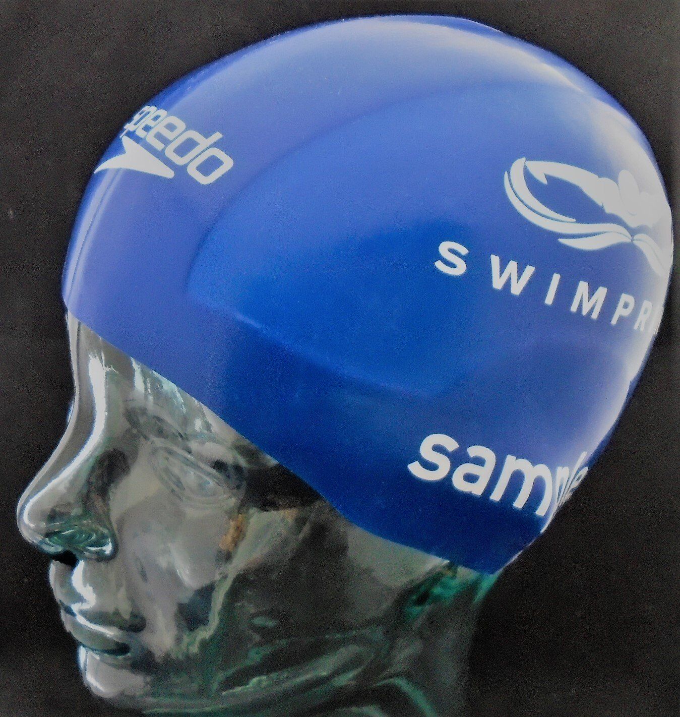 A blue speedo swim cap is on a mannequin head