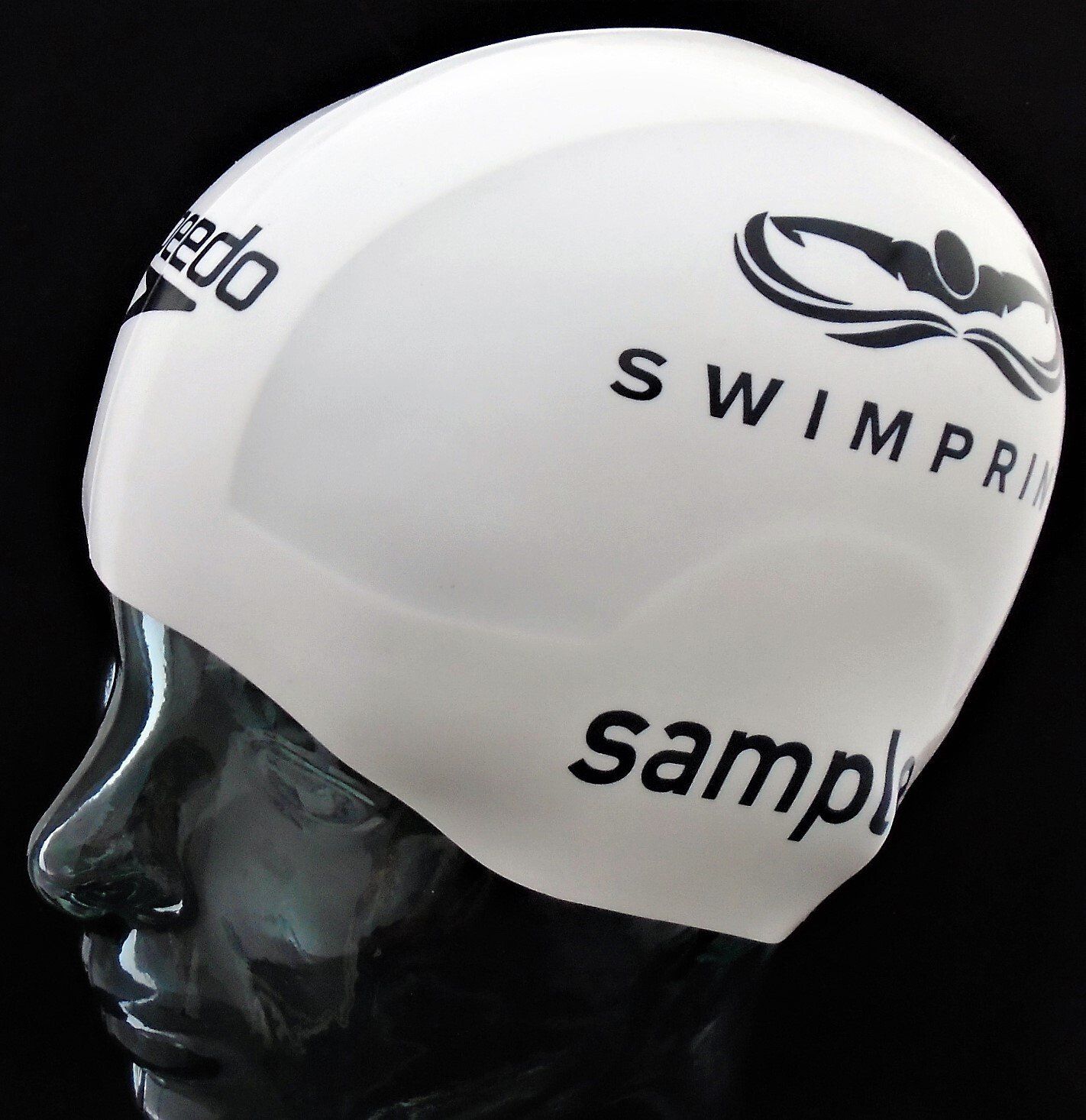 A white speedo swim cap is on a mannequin head