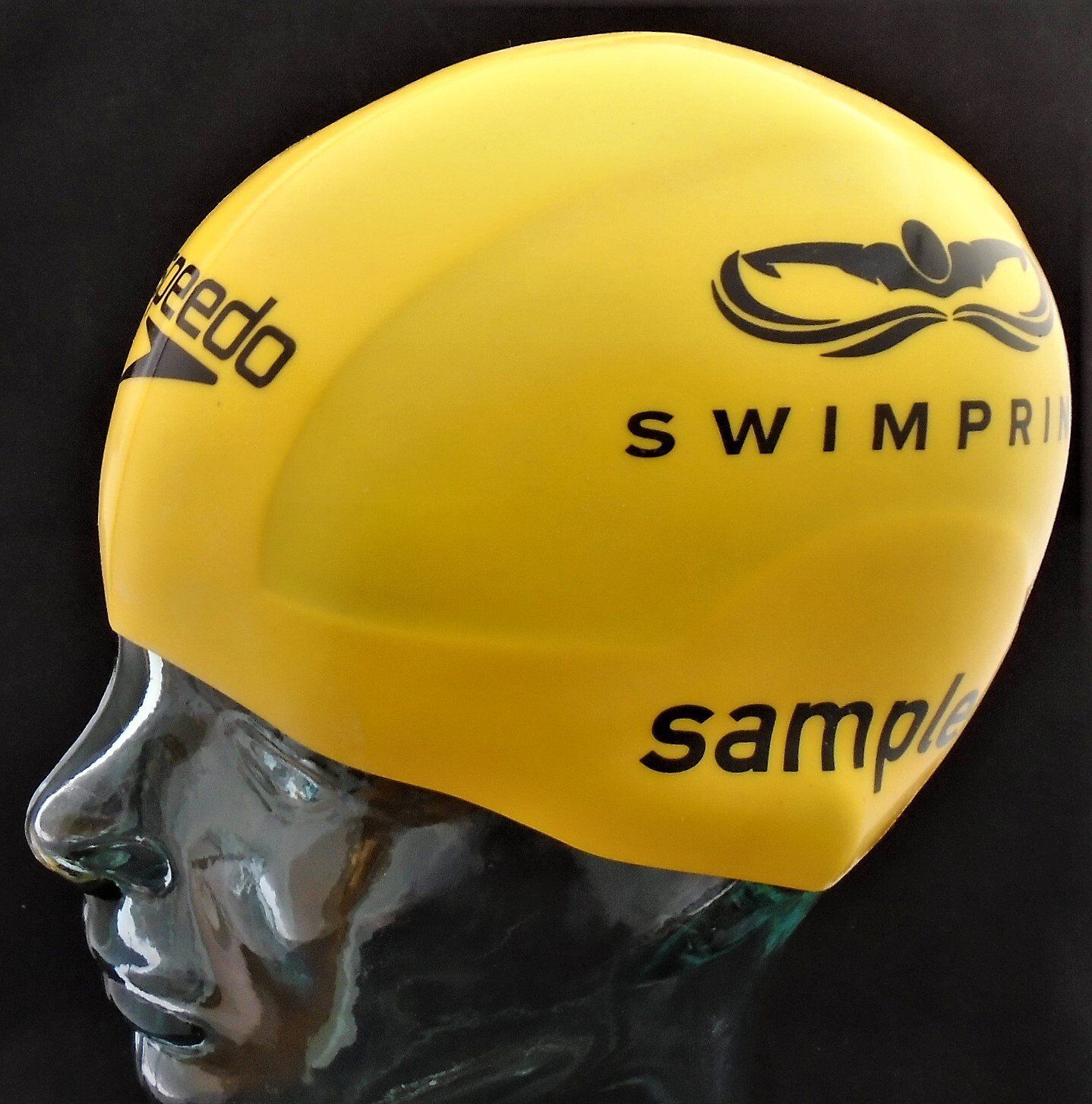 A yellow speedo swim cap is on a mannequin head